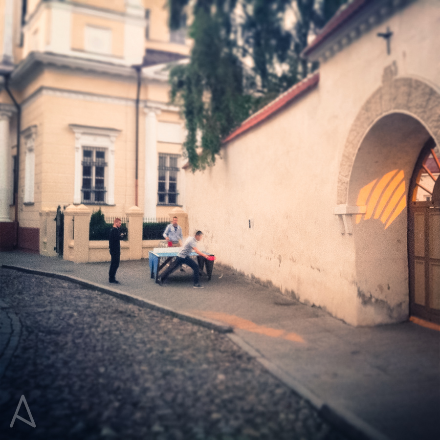 Picture I took on a Sunday night at around 10:30PM. It's still light outside and some guys are playing ping pong in the middle of the street in Old Town.